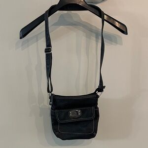 Treviso medium black faux leather crossbody purse with a front pocket.